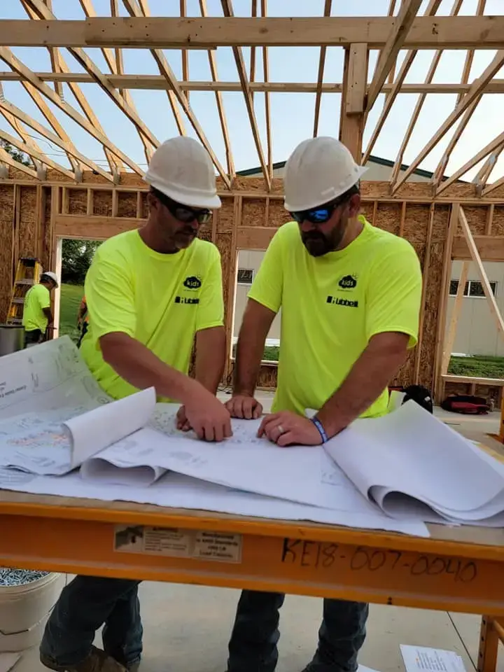 two Kline Electric employees reviewing a project plan
